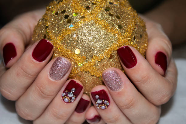 istock Female hands holding a gold Christmas ball 1048843178