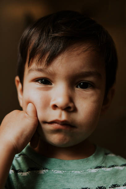 istock Skeptical face portrait of a kid 1048843500