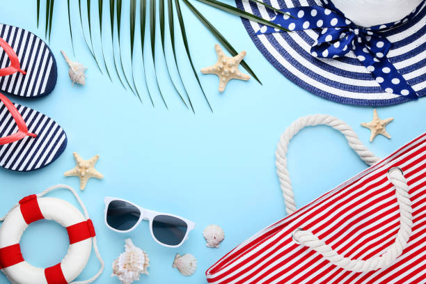istock Beach accessories with seashells and palm leaf on blue background 1048852596