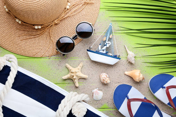istock Beach accessories with seashells on green wooden table 1048853140