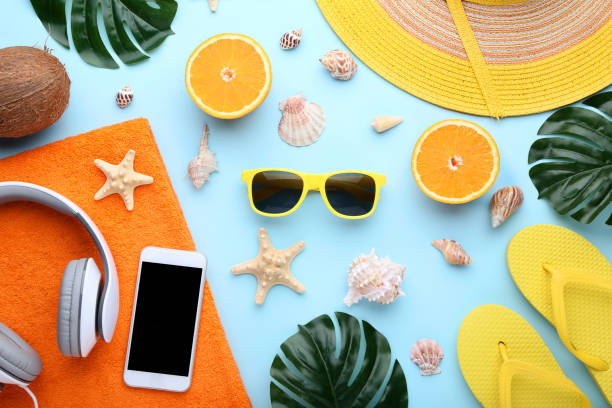 istock Summer accessories with seashells and orange fruit on blue background 1048853346