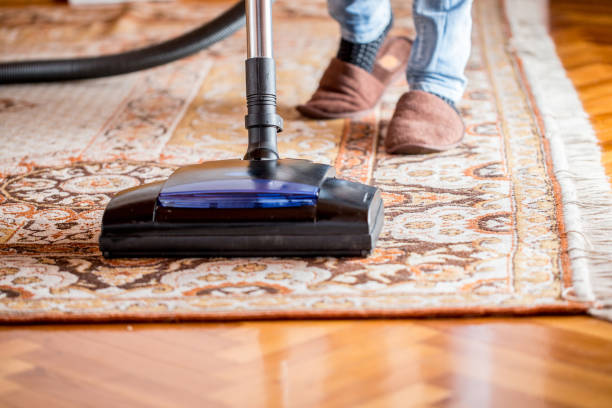 istock Woman Vacuum Cleaning Old Rug 1048855970