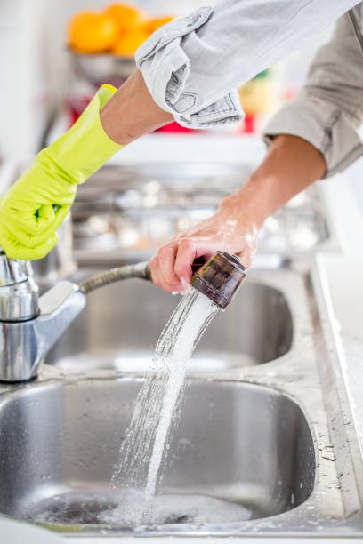 istock Woman Washing Kitchen Sink 1048855980