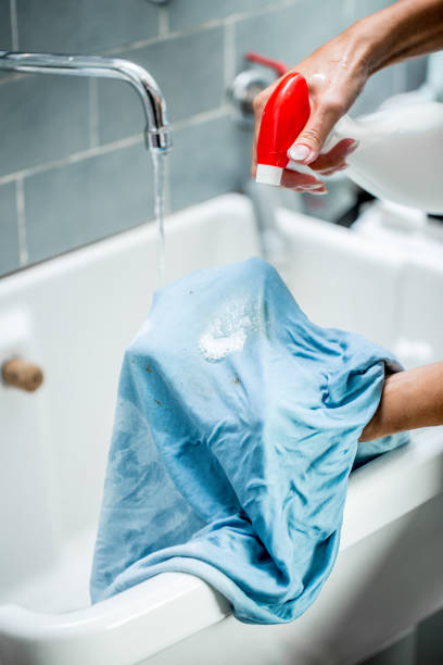 Woman Using Cleaning Product To Clean Stained Textile