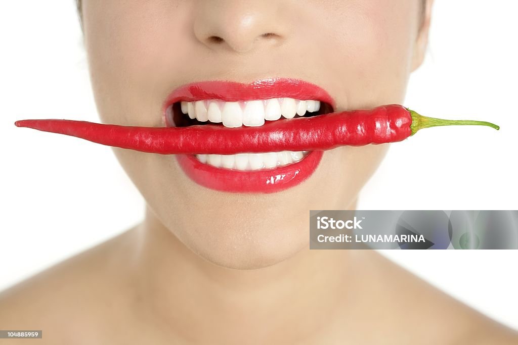 Beautiful woman teeth eating red pepper Beautiful woman teeth eating red hot chili pepperBeautiful woman teeth eating red hot chili pepper 20-24 Years Stock Photo