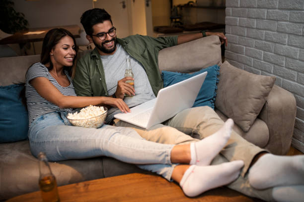 istock Young couple watching a movie on a laptop. 1048864006