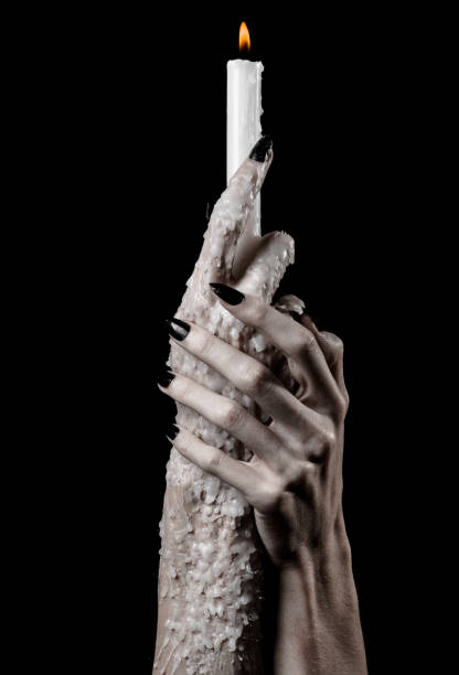 istock hands holding a candle, a candle is lit, black background, solitude, warmth, in the dark, Hands death, hands witch 1048867400