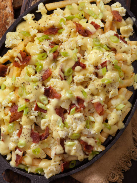 istock Breakfast Poutine with Hollandaise Sauce, Scrambled Eggs, Bacon and Cheese Curds 1048873552