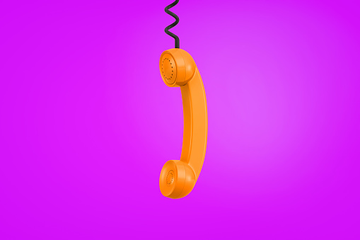 3d rendering of a orange retro phone receiver hangs from a black cord on a purple background. Communication and talking. Receive information. Call us.