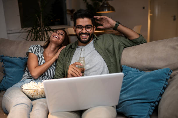 istock Young couple watching a movie on a laptop. 1048875948