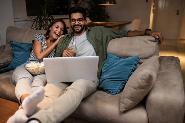 istock Young couple watching a movie on a laptop. 1048875974
