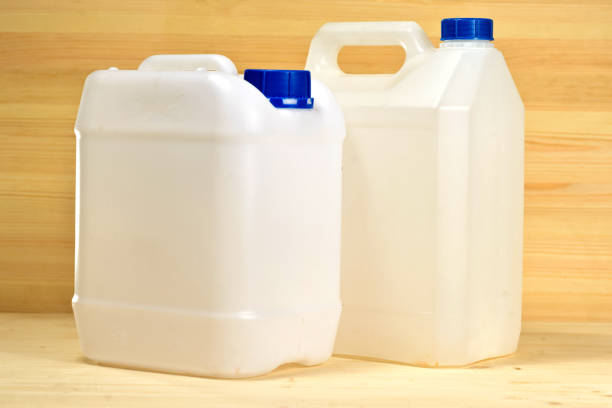 istock White plastic containers (gallon) on the background of wooden wall 1048876114