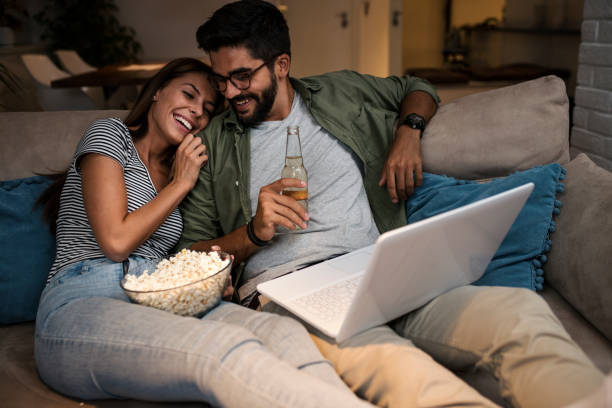 istock Young couple watching a movie on a laptop. 1048876612