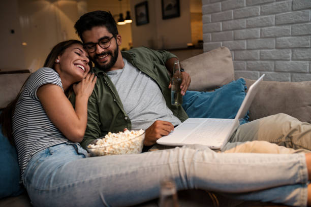 istock Young couple watching a movie on a laptop. 1048876632