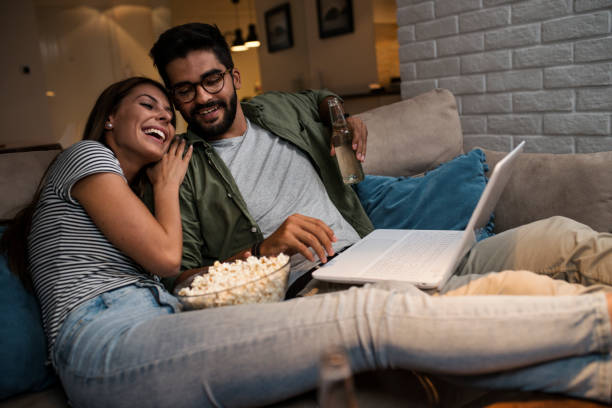 istock Young couple watching a movie on a laptop. 1048876694