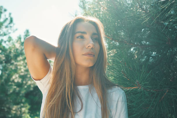 istock Close-up young woman with beautiful face features enjoying sun 1048881956