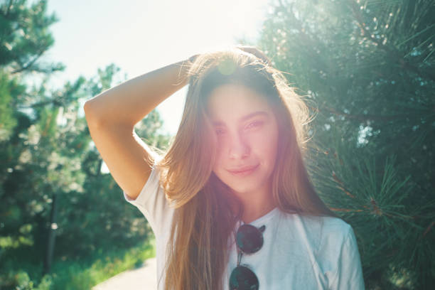 istock Close-up young woman with beautiful face features enjoying sun 1048881982