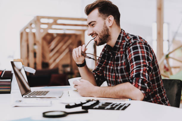 istock Eyeglasses. Laptop Screen. Cup of Coffee. Desk. 1048882676