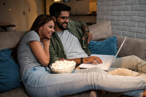 istock Young couple watching a movie on a laptop. 1048886096