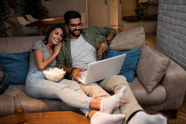 istock Young couple watching a movie on a laptop. 1048886252