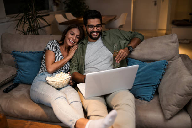 istock Young couple watching a movie on a laptop. 1048886258