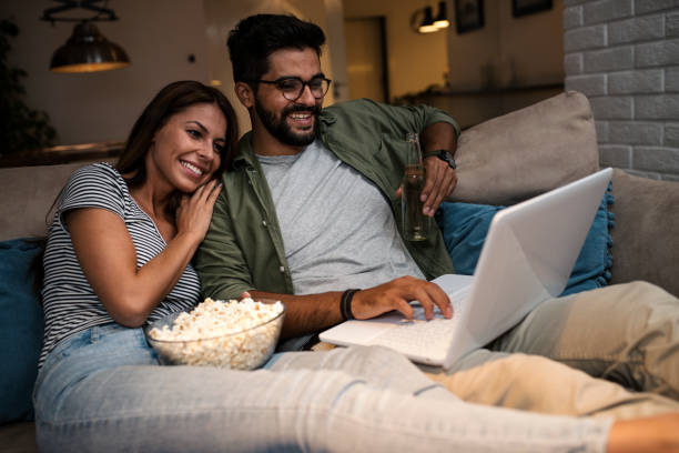 istock Young couple watching a movie on a laptop. 1048886264