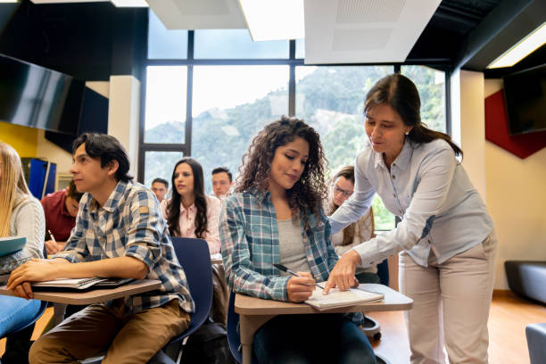 istock Teacher talking to a female student in class 1048886498