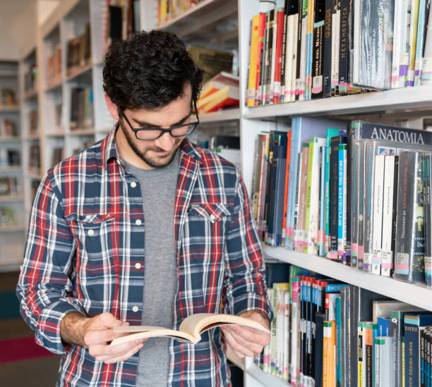 istock Happy male student researching at the library 1048886784