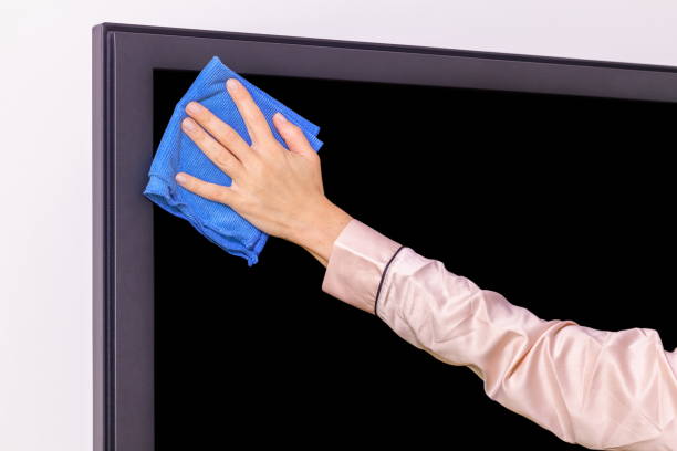 istock Hand with a rag wiping the TV screen 1048887004
