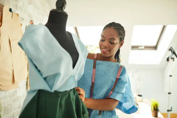 Young African female designer working in her workshop.