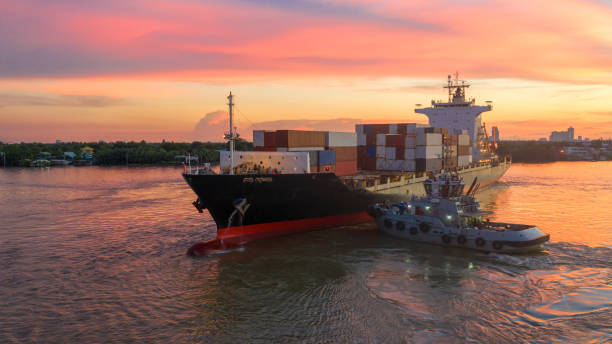 istock Container ship in export and import business and logistics. Shipping cargo to harbor by crane. Water transport International. Aerial view and top view. 1048890682