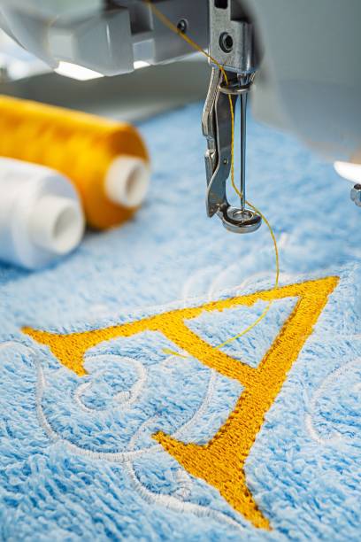 istock Embroidery machine and alphabet logo on towel 1048891086