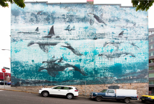 Victoria Island, Vancouver, B.C., Canada. Wall mural representing a pod of whales and marine life in the sea, covering a complete building wall end in old town Victoria, Victoria Harbour, Vancouver, B.C., Canada