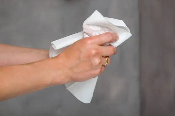 Close up view of female hands holding white towel