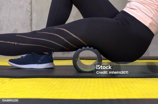 Close Up View Of Woman Exercising With Foam Roller Stock Photo - Download Image Now - Rolling, Exercising, Conveyor Belt