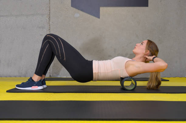 istock Young blonde woman training with roller at gym 1048895658