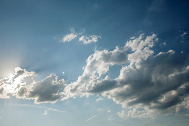 istock the sun breaks through the cumulus clouds on the blue sky 1048906580