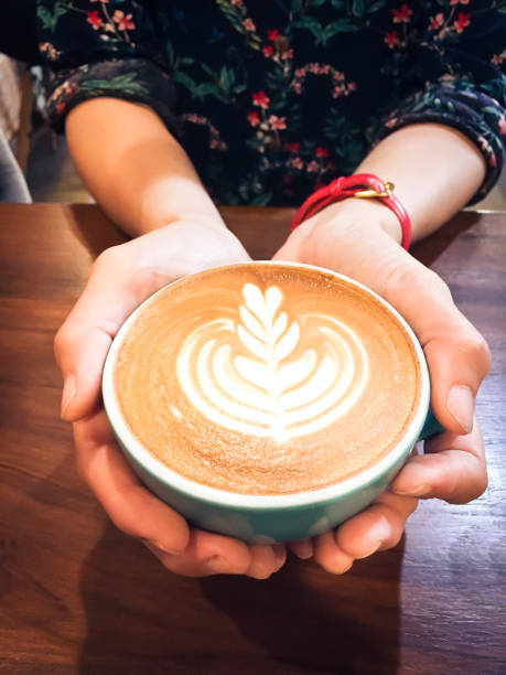 istock Woman hands holding coffee cup selective focus. 1048910944