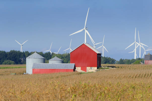 istock Barn and silos dwarfed by giant wind turbines in distance. 1048912548