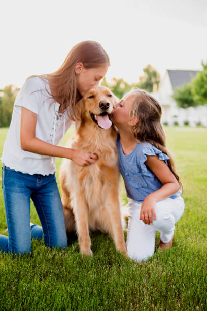 istock Littles girls with pet dog. 1048916396