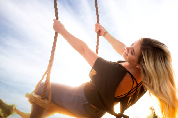 istock Young Woman Swinging 1048916540