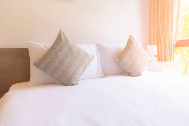 istock Pillow on the bed with sunlight. 1048918602
