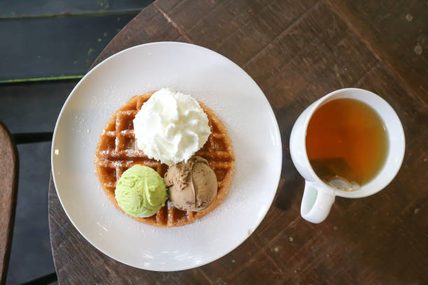 waffle with ice cream topping and hot tea