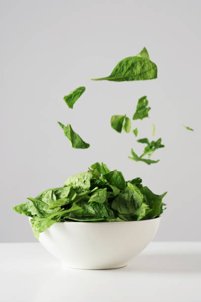 istock raw spinach leaves in a white bowl 1048927038