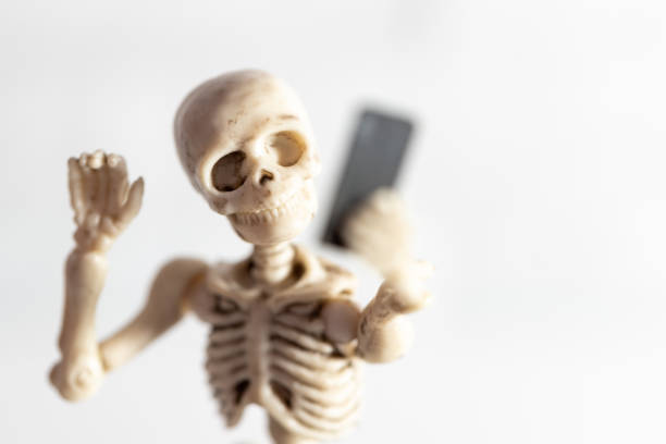 istock Selfie, skeleton taking self portrait with smartphone 1048927728