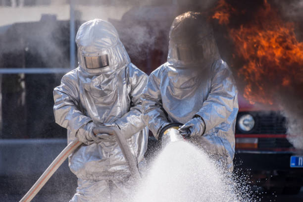 Firefighters in fire-fighting drill. stock photo