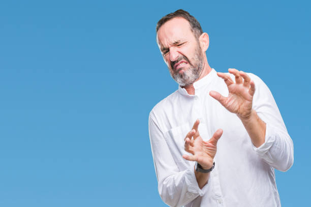 istock Middle age hoary senior man over isolated background disgusted expression, displeased and fearful doing disgust face because aversion reaction. With hands raised. Annoying concept. 1048928114