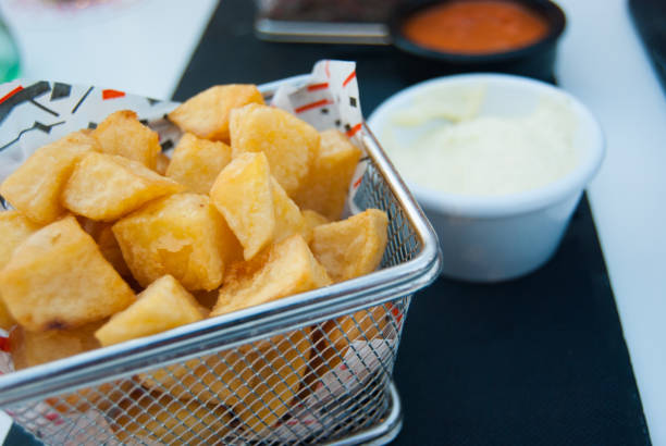 Fried potatoes in a small metal basket