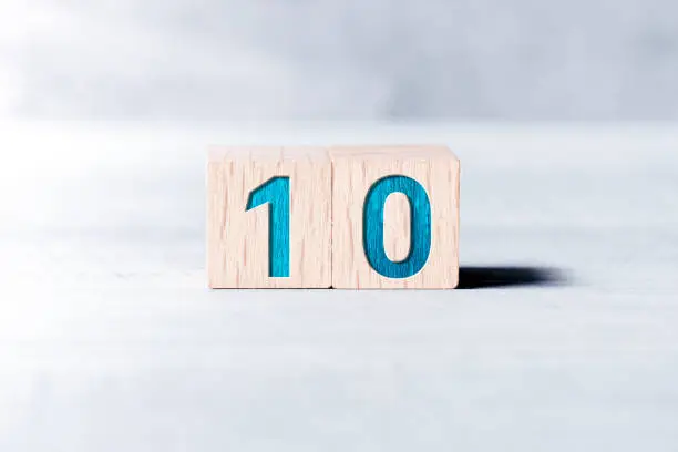 Number 10 Formed By Wooden Blocks On White Table