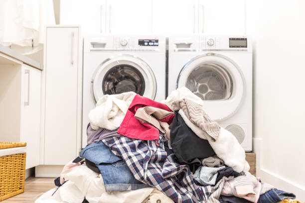Laundry room with a pile of dirty clothes Laundry room with a pile of dirty clothes on floor utility room stock pictures, royalty-free photos & images